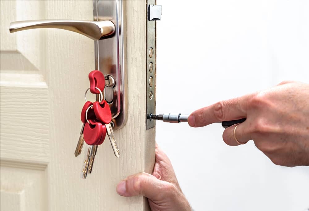 locksmith fixing the lock on the inside of a door